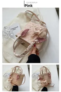 Pink bucket bag with vintage carriage print, scarf handle and cartoon charm detail
