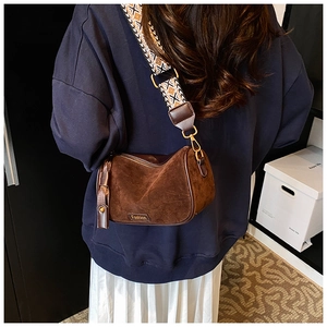 Detail of vintage brown suede pillow bag with ethnic geometric jacquard wide strap