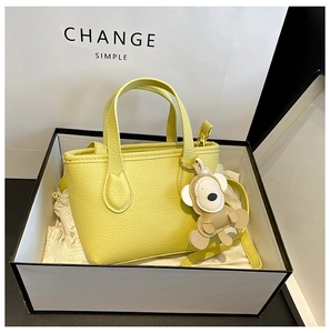 Yellow lychee pattern leather mini bucket bag with bear charm in a premium gift box