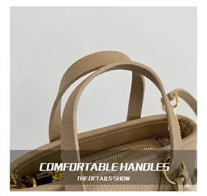 Close-up of light brown lychee textured leather bucket bag with golden metal ring detail