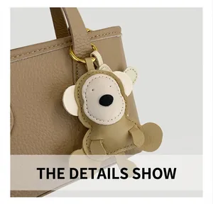 Close-up of animal-shaped leather charm with litchi texture on a brown bucket bag