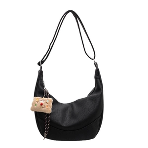 Black large capacity hobo bag with a cute plush charm and adjustable shoulder strap