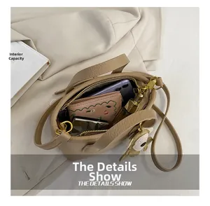 Top view of lychee leather bucket bag showing interior space with phone and wallet