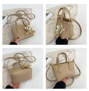 Detailed views of a khaki lychee leather bucket bag with top handles and monkey charm
