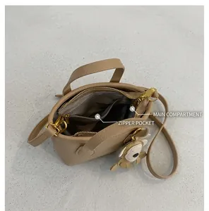 Top view of litchi texture bucket bag showing main compartment and zipper pocket detail