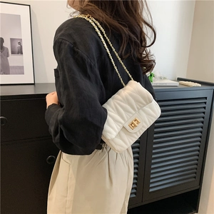 White quilted crossbody bag with gold chain strap and elegant V-pattern finish