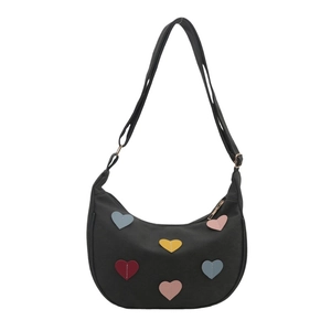 Chic black hobo bag with colorful heart patches and adjustable shoulder strap