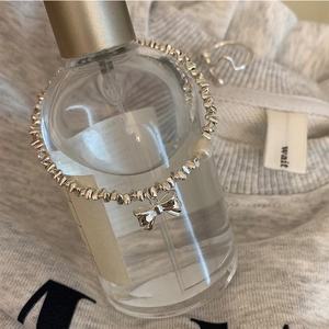 Elegant S925 silver beaded bracelet with pearl and bow pendant on glass bottle