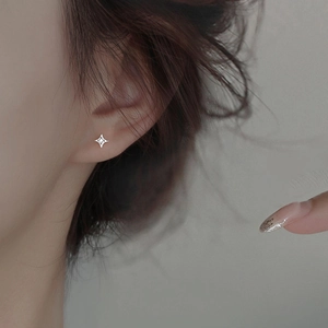 Minimalist S925 sterling silver star stud earring with a clear zircon on ear lobe