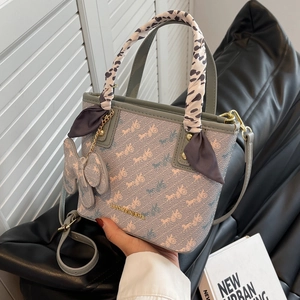Light blue patterned tote bag with animal print scarf handles and adjustable strap