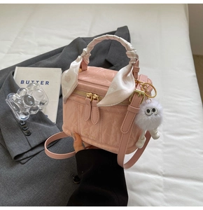 Pink pleated mini box bag with silk scarf handle and plush monster charm detail