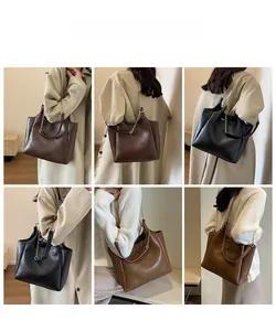 Model display of vintage tote bags with rhombic pattern and metal chain straps