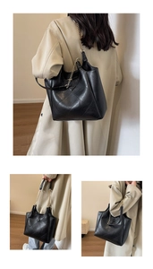 Close-up of black quilted leather tote bag with large diamond stitching and chain strap