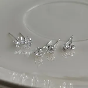 Detailed view of three different sizes of S925 silver star stud earrings with zircon
