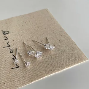 Detailed view of S925 silver star and flower stud earrings with sparkling cubic zirconia