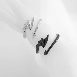 Adjustable angel and demon wing rings set in silver and black punk aesthetic