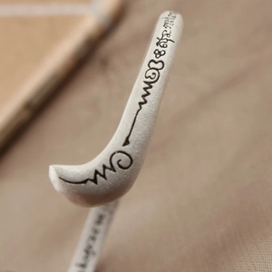 Macro shot of S925 silver fox bangle with engraved scriptures and matte finish