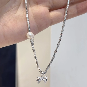 925 silver necklace featuring a metal bow pendant and round white pearl on square link chain