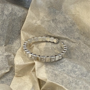 Irregular square patchwork open ring with polished and textured silver surfaces