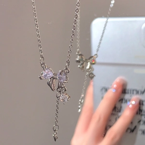 Elegant 925 sterling silver bow necklace with sparkling zircon tassels and heart pendant