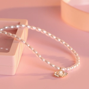S925 silver camellia pearl necklace with a white flower pendant on pink background