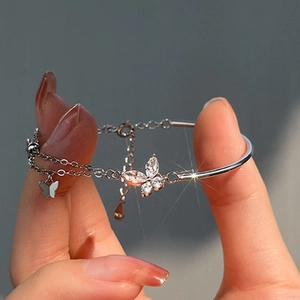 Close-up of butterfly zircon silver bracelet featuring a hybrid half-chain half-bangle design