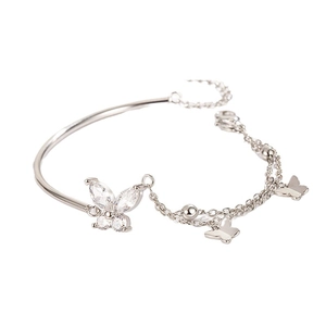 Silver butterfly bracelet featuring cubic zirconia stones and a dual chain-bangle design