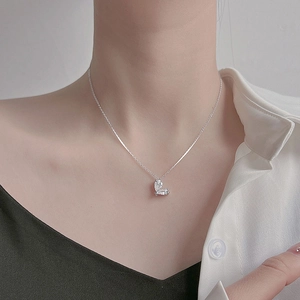 Close-up of S925 silver heart necklace with zircon stones on a model neck