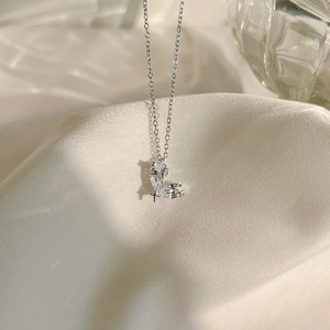 Detail of silver S925 necklace featuring dual pear-cut cubic zirconia and star charm