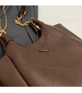 Detailed view of the diamond-quilted brown faux leather and triangle fashion emblem