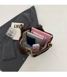 Top view of spacious main compartment in brown leather tote bag with office essentials
