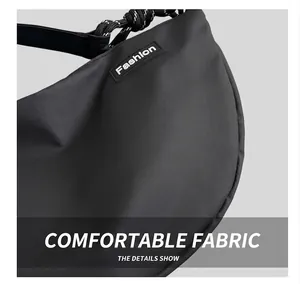 Close-up of black crossbody crescent bag with durable nylon cross-texture and wide strap