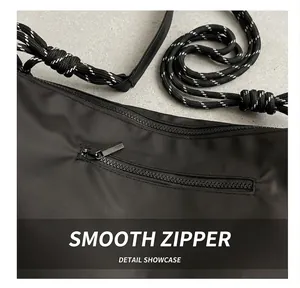 Detail of smooth metal zipper and durable nylon fabric on a sporty crossbody bag