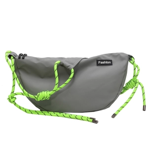 Detail of grey crescent crossbody bag with vibrant neon green braided rope shoulder strap