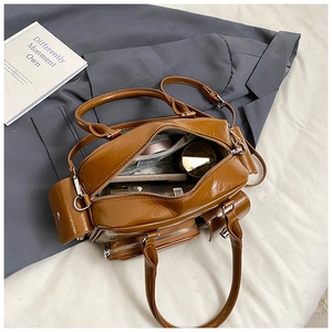 Detail of a brown retro oil-wax tote bag showing internal capacity with daily essentials