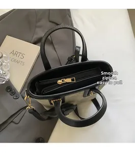 Close-up of smooth metal zipper and spacious interior of the textured bucket bag