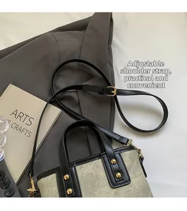 Detail showing the adjustable leather strap and golden metal hardware of the bucket bag