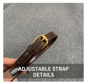 Detail of adjustable dark brown oil wax leather shoulder strap with gold metal buckle