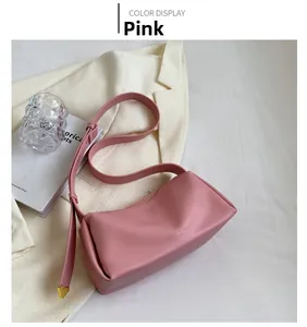 Pink rectangular leather shoulder bag with gold hardware detail on a chic blazer background