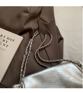 Detail of silver metallic tote with pleated texture leather and chain shoulder strap