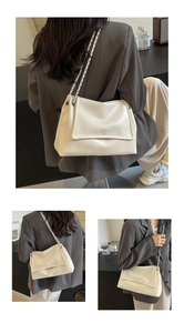 Close-up of white wrinkled leather shoulder bag with silver chain and WEGOOD logo