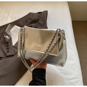 Detail of silver metallic textured underarm tote with WEGOGO logo and chain strap