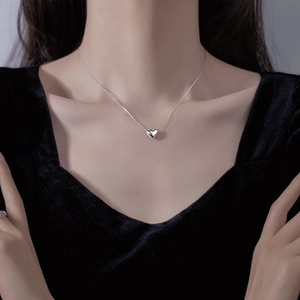 Minimalist silver heart pendant necklace on model with polished mirror finish