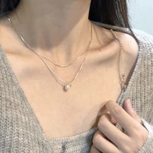 Elegant S925 silver double-layered necklace with pearl pendant on a knit sweater
