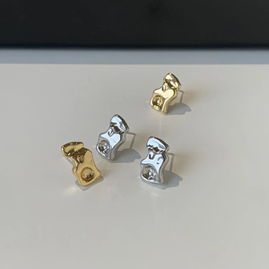 Irregular liquid metal wave earrings in gold and silver finish with lava texture