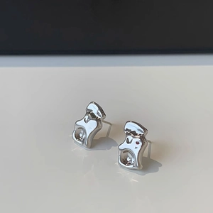 Detailed close-up of silver irregular wave stud earrings with liquid metal polished texture