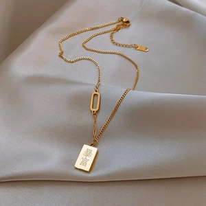 Golden bar pendant necklace with Bao Fu engraving on champagne silk background