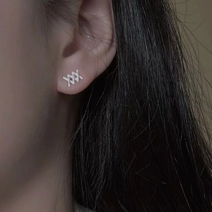 Minimalist S925 silver triple cross earrings worn by model for elegant styling