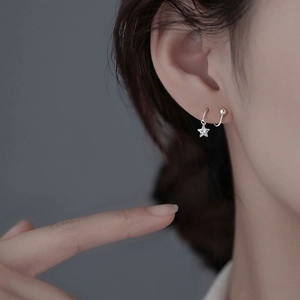 Minimalist S925 sterling silver irregular star screw earrings worn by a model