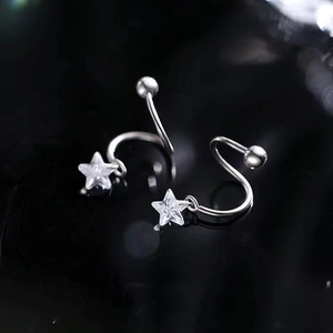 Macro shot of S925 silver spiral star earrings with sparkling zircon on black mirror